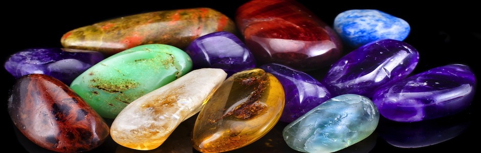 Group of natural colorful raw gemstones on black  background